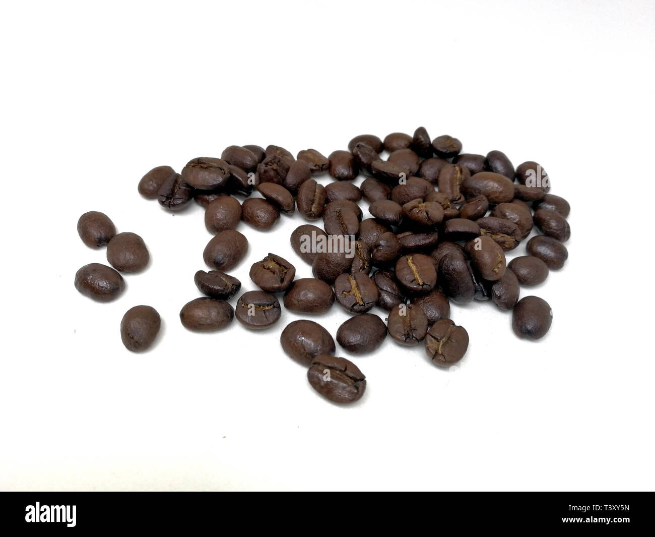 roasted coffee beans isolated in white background Stock Photo - Alamy