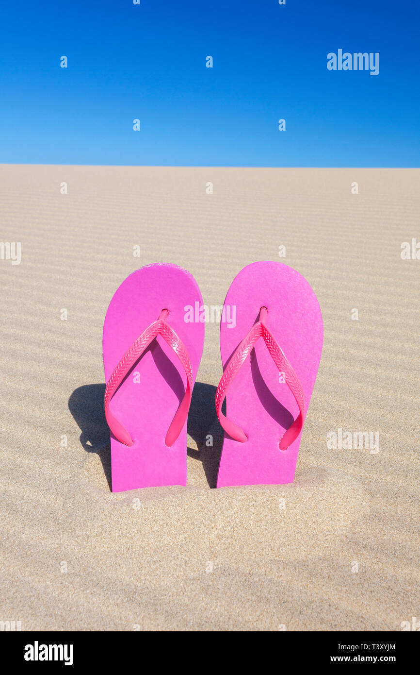 Pink flip flops in sand Stock Photo - Alamy