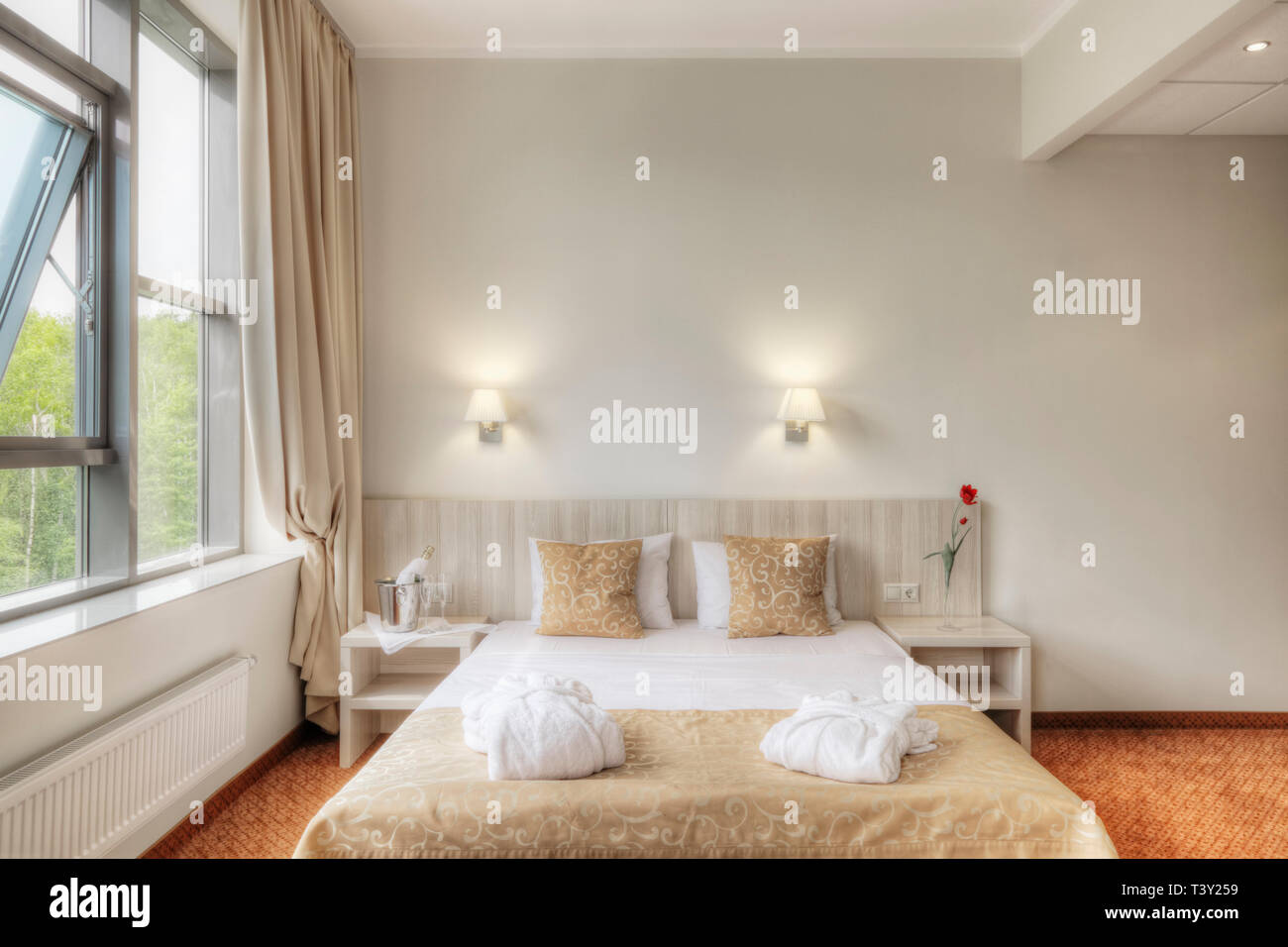 Folded robes on bed in hotel room Stock Photo Alamy