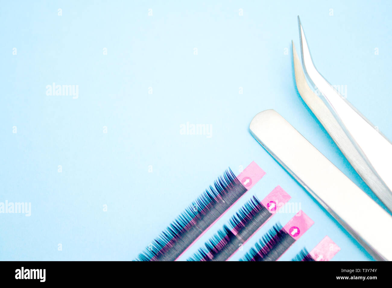 Download Beauty And Fashion Concept Tools For Eyelash Extension Procedure Two Tweezers With Artificial Black Lashes On Blue Background Copyspace Mockup Stock Photo Alamy