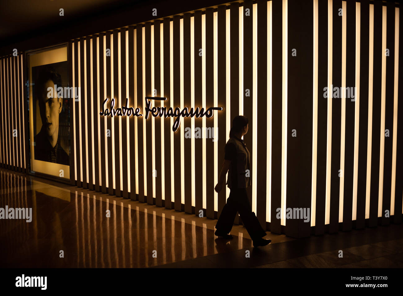 04.04.2018, Singapore, Republic of Singapore, Asia - A woman is walking by a retail store of the Salvatore Ferragamo fashion brand in 'The Shoppes'. Stock Photo