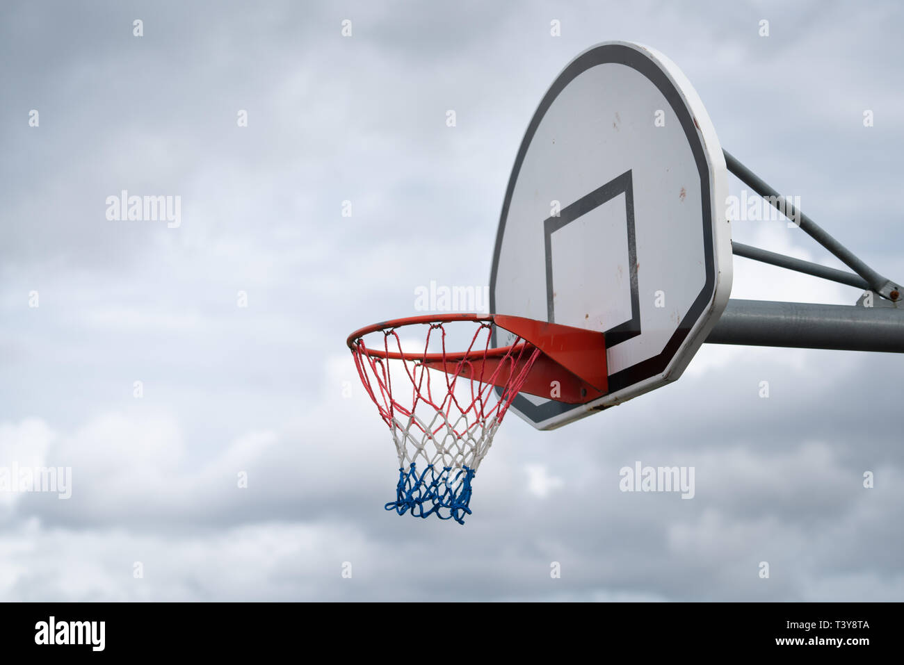 Basketball backboard against cloudy sky Stock Photo