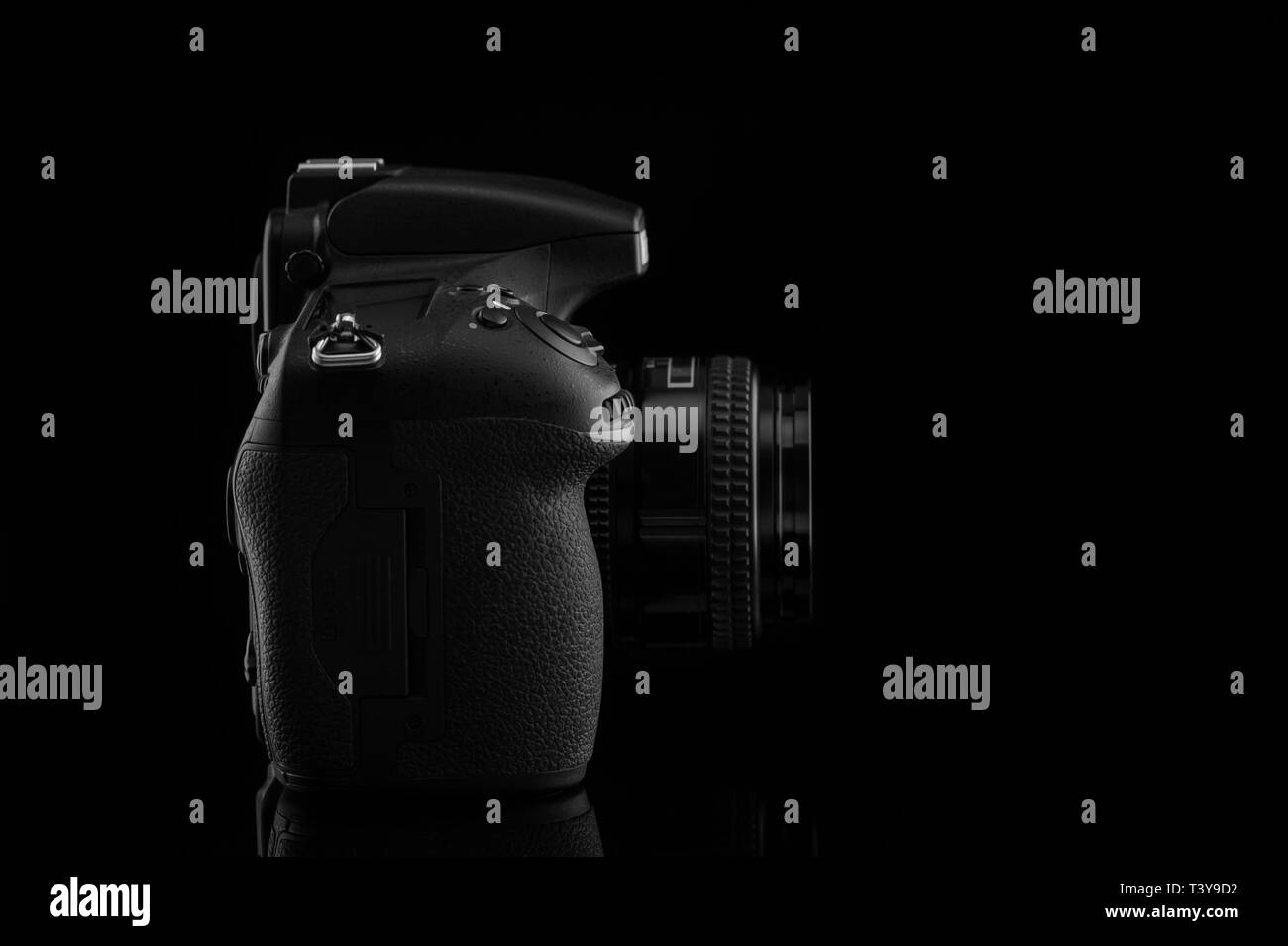Camera with lens on black background. Stock Photo