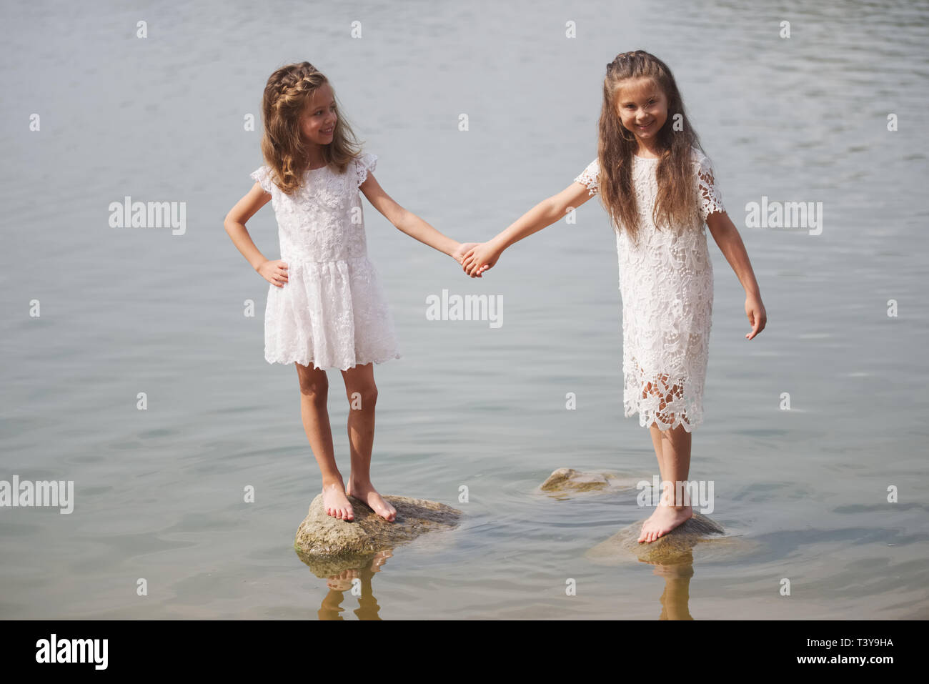 portrait of cute little girls in sumer lake Stock Photo
