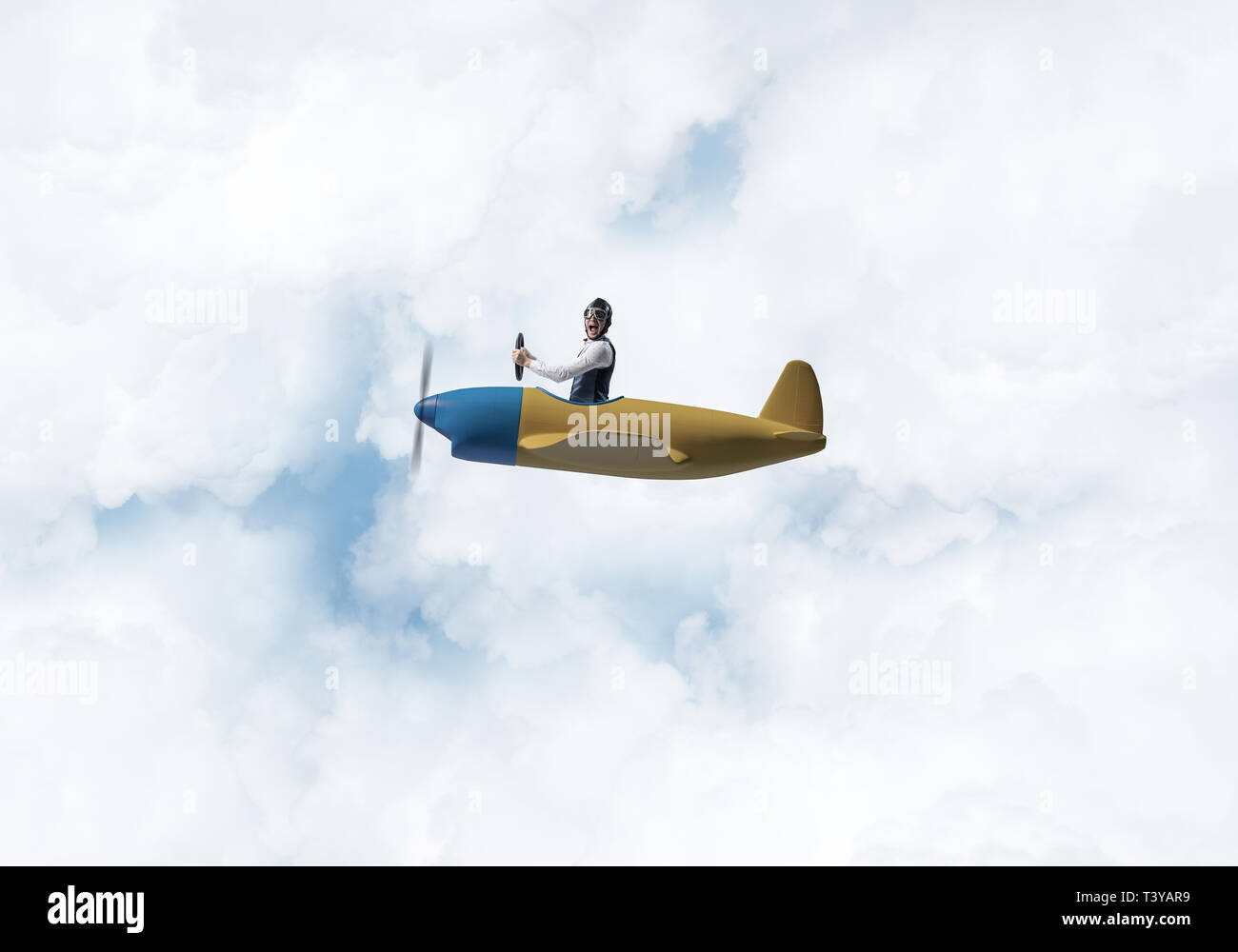 Man in aviator hat driving propeller plane Stock Photo Alamy