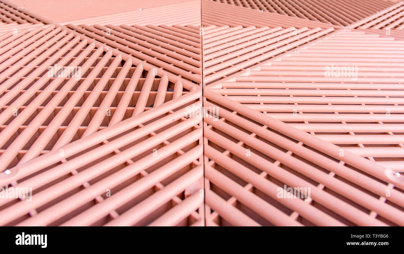 Brown plastic rods as a permeable walkway plate for growth of the lawn Stock Photo