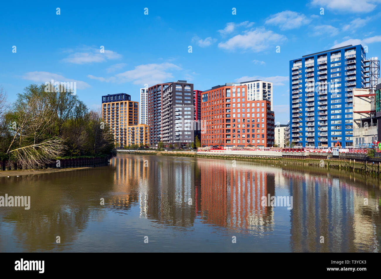 New apartments along the river bank at Bow Creek, in Poplar,  London Docklands, UK Stock Photo