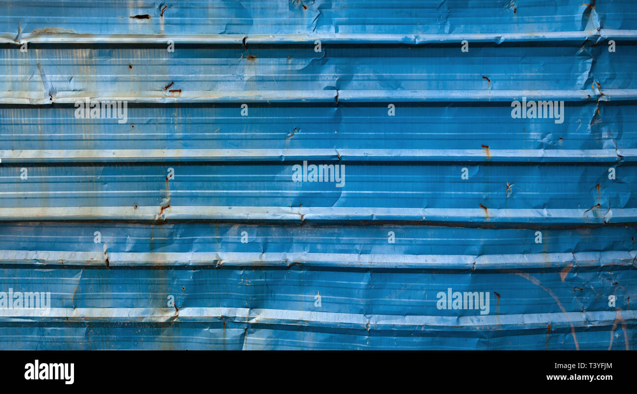 Old blue grungy corrugated metal wall, frontal background photo texture Stock Photo