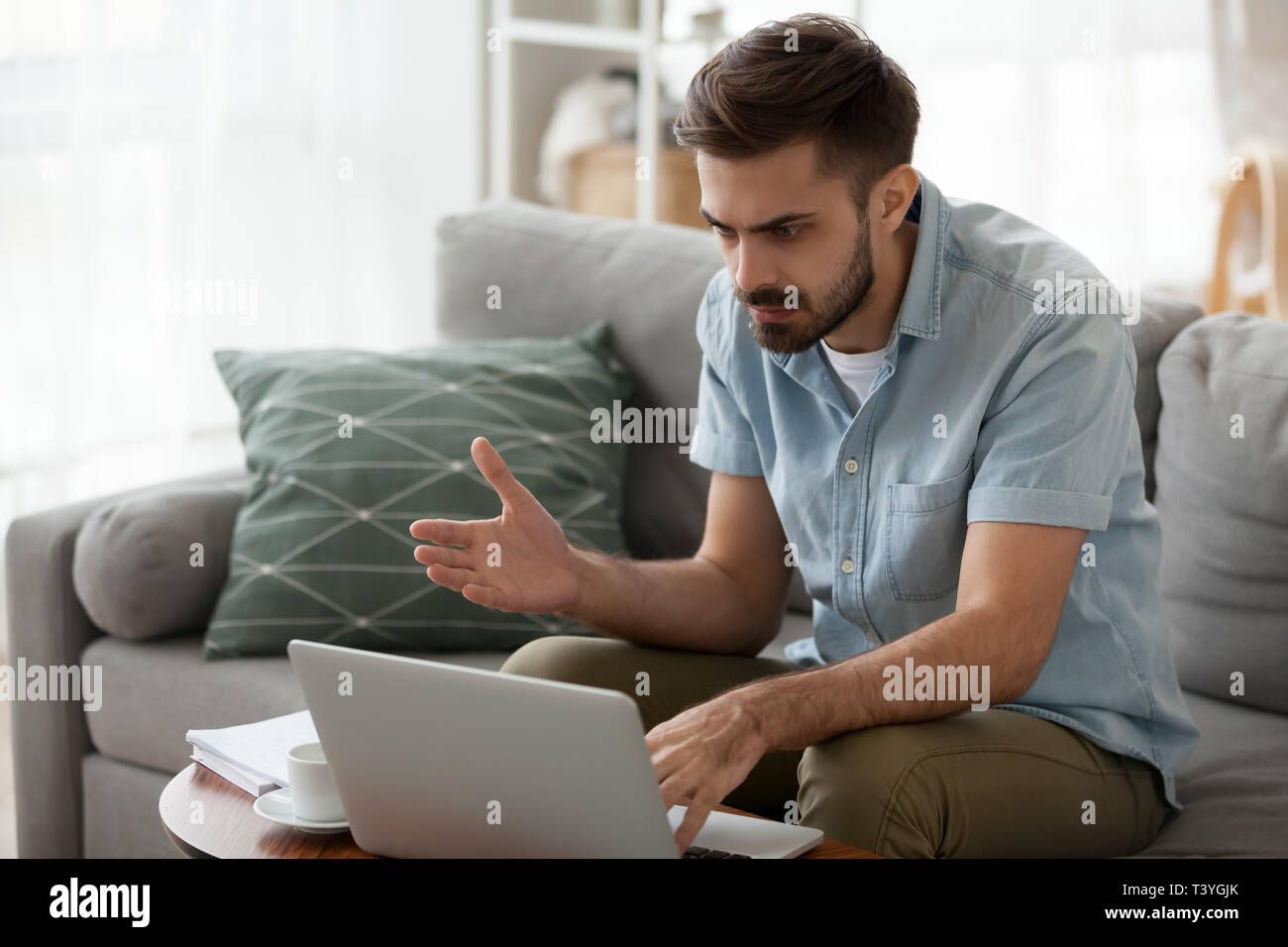 Outraged angry man reading bad news, having problem with laptop Stock Photo
