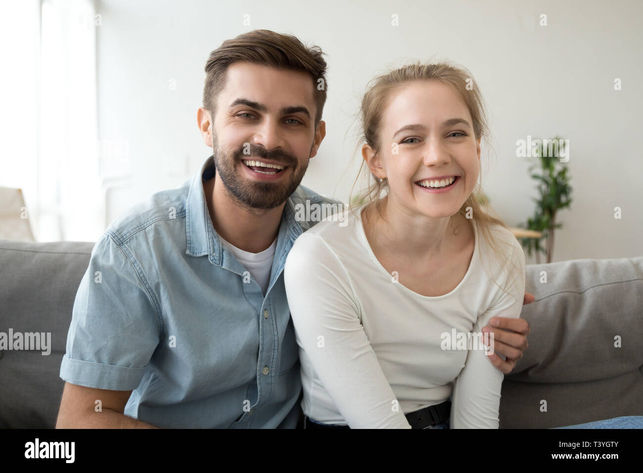 Head shot portrait of smiling couple, look at camera, making video call Stock Photo