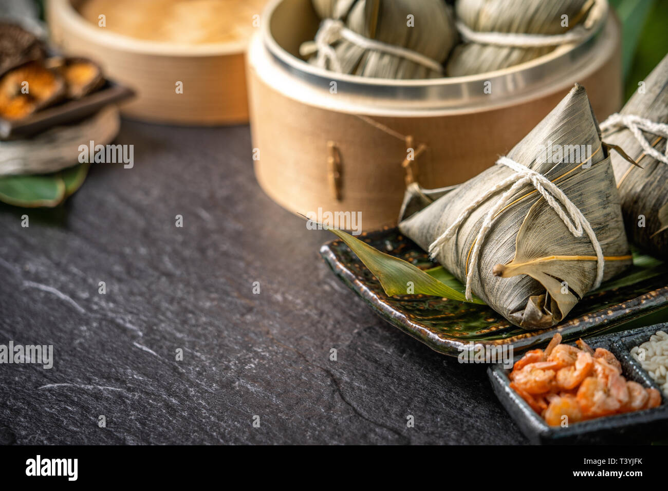 Close up, copy space, famous asian tasty handmade food in dragon boat(duan wu) festival, fresh from steamer steamed rice dumplings shaped pyramidal wr Stock Photo