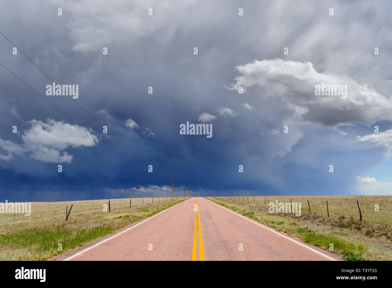 Storm clouds over open road, Rush, Colorado, United States Stock Photo
