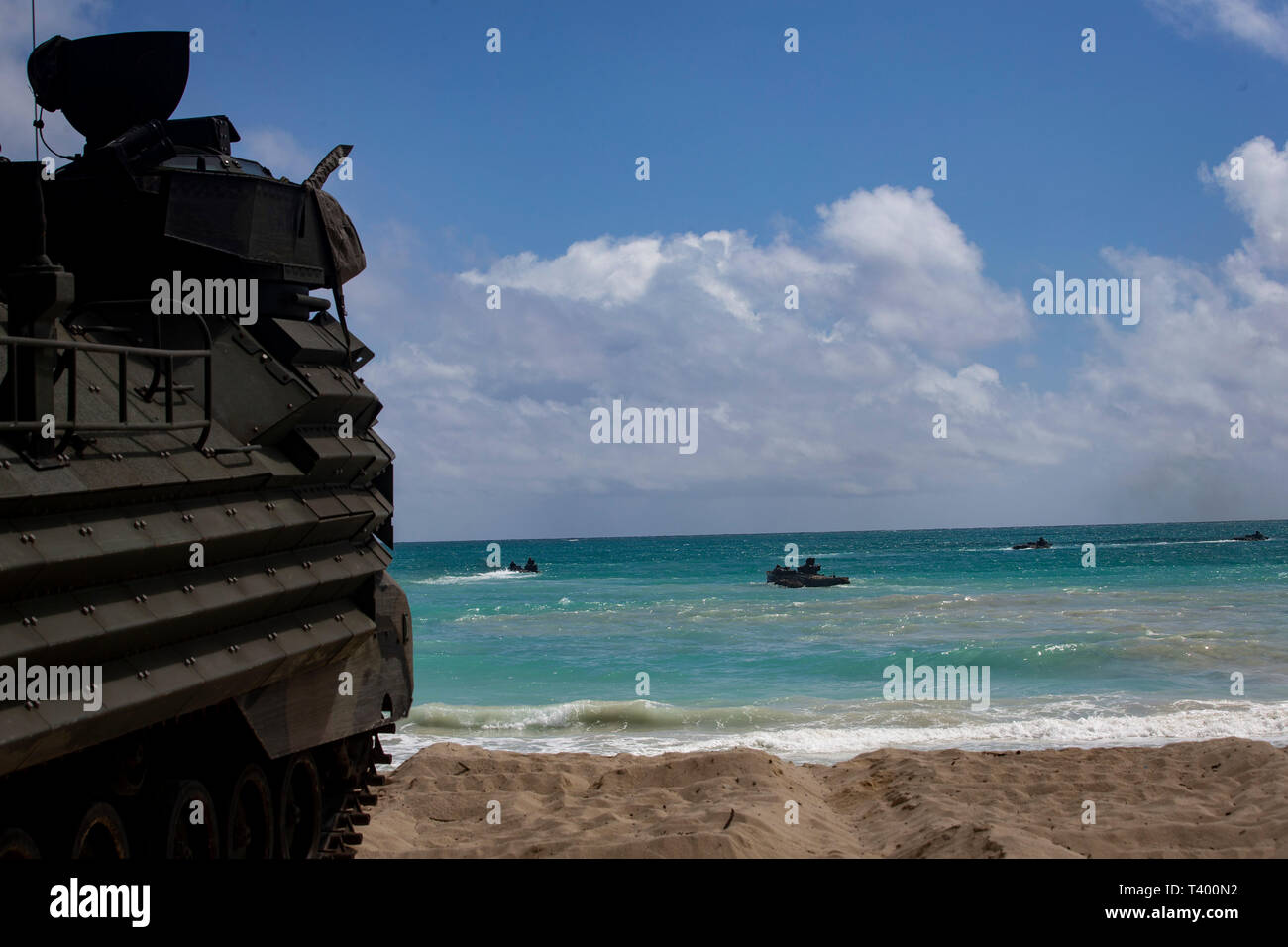 A U.S. Marine Corps amphibious assault vehicle assigned to Combat Assault Company, 3d Marine Regiment, prepares to breach the water during an amphibious assault exercise at Marine Corps Training Area Bellows, Marine Corps Base Hawaii, Apr. 9, 2019. The unit conducted a simulated beach assault to improve their lethality and cooperation, as a mechanized unit and force in readiness. (U.S. Marine Corps photo by Sgt. Alex Kouns) Stock Photo
