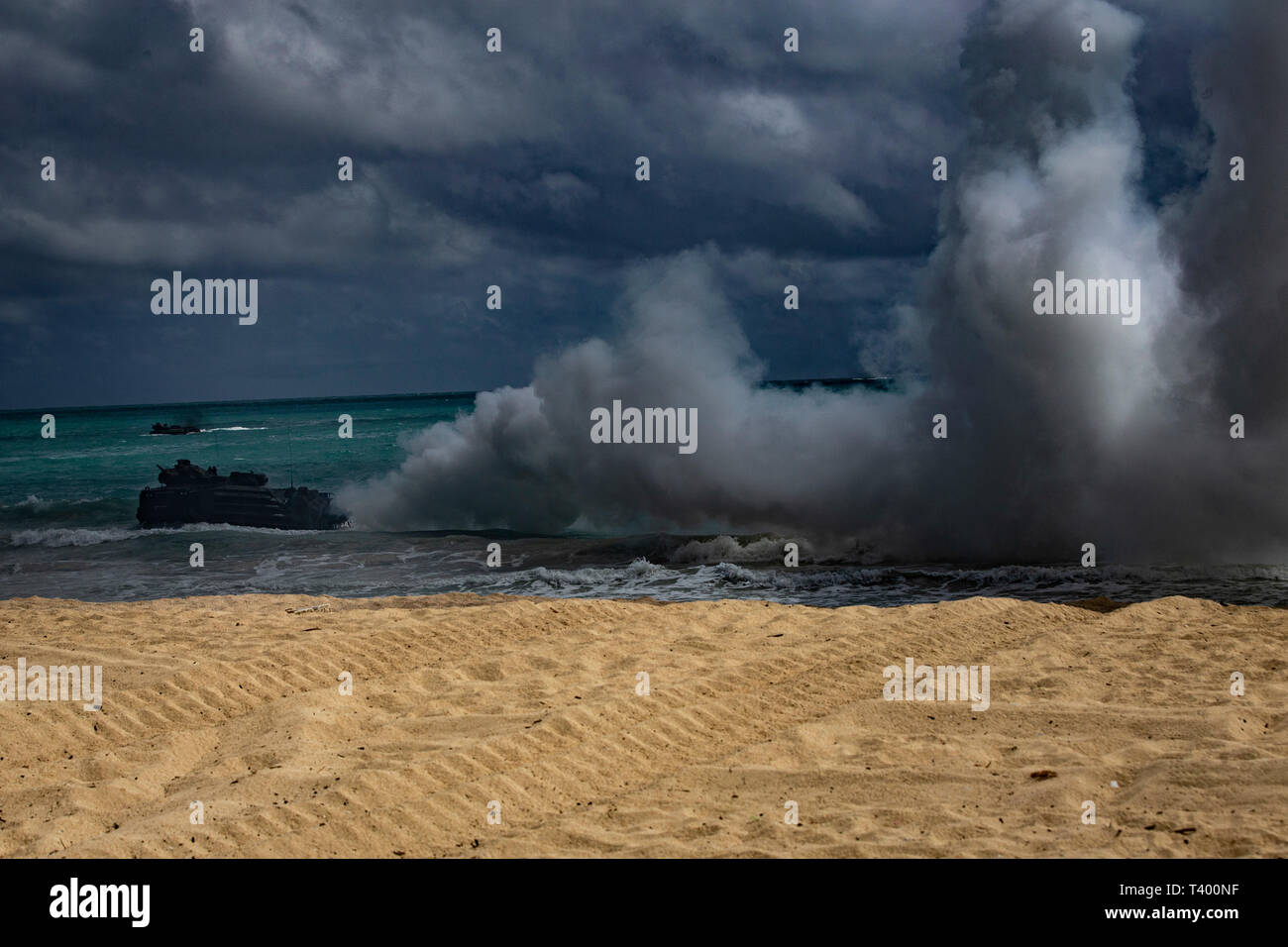 A U.S. Marine Corps amphibious assault vehicle assigned to Combat Assault Company, 3d Marine Regiment, creates a smokescreen to conceal a simulated amphibious beach assault, Marine Corps Base Hawaii, Apr. 9, 2019. The unit conducted a simulated beach assault to improve their lethality and cooperation, as mechanized unit and force in readiness. (U.S. Marine Corps photo by Sgt. Alex Kouns) Stock Photo