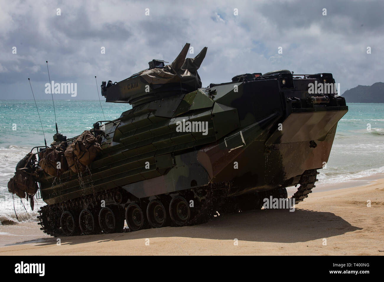 A U.S. Marine Corps amphibious assault vehicle assigned to Combat Assault Company, 3d Marine Regiment, comes ashore during an amphibious assault exercise at Marine Corps Training Area Bellows, Marine Corps Base Hawaii, Apr. 9, 2019. The unit conducted a simulated beach assault to improve their lethality and cooperation, as a mechanized unit and force in readiness. (U.S. Marine Corps photo by Sgt. Alex Kouns) Stock Photo