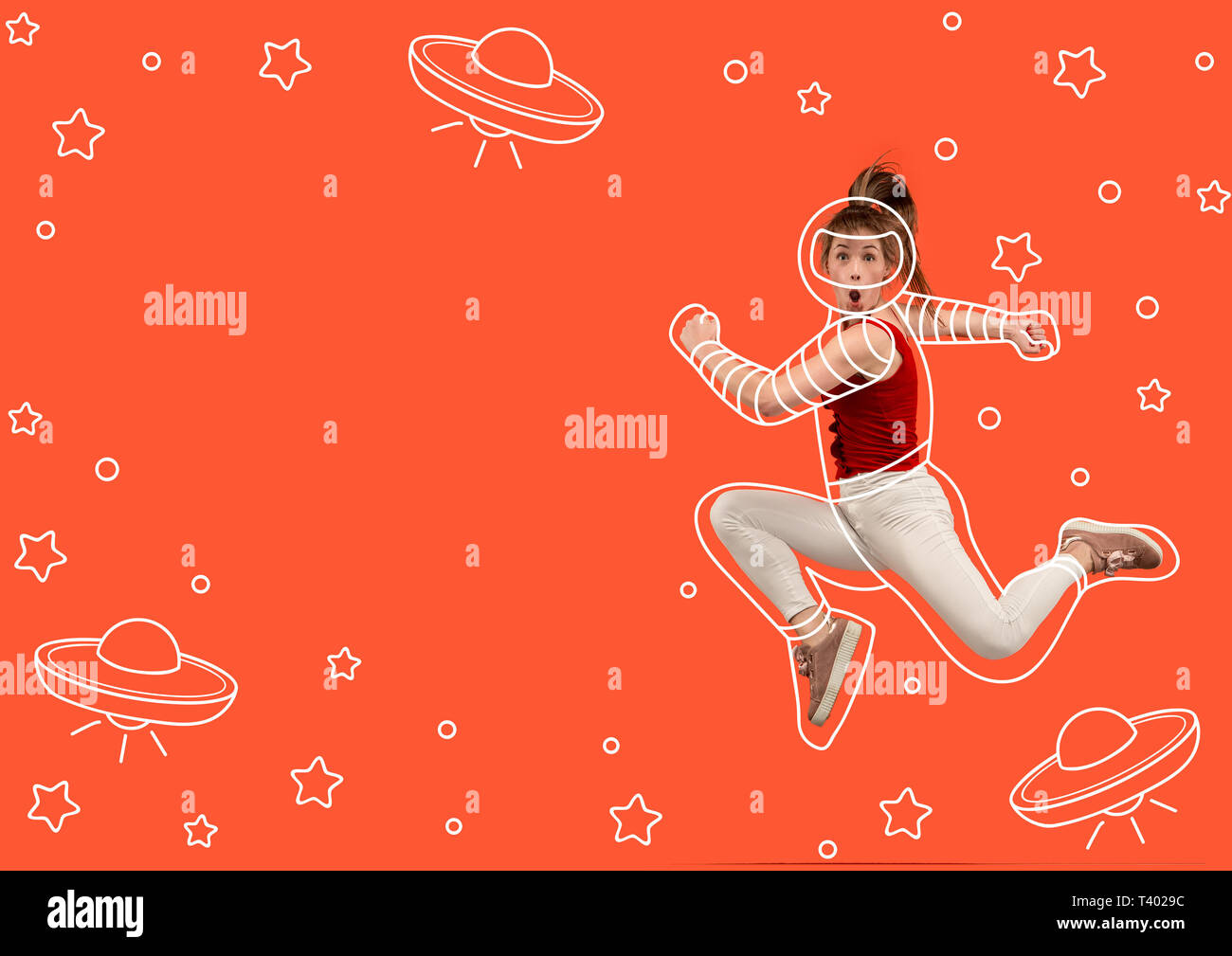 Running right to the stars. Dreaming about cosmonaut profession or travel the cosmos. Young woman in drawing imaginary spacesuit against bright red background. Concept of dreams. Negative space. Stock Photo