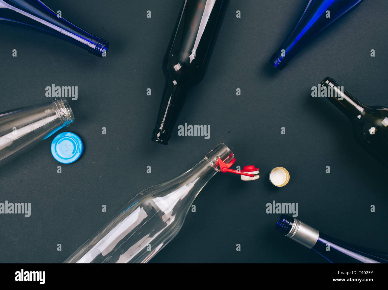 Reduce reuse recycle. Empty colorful glass bottles and metal lids are