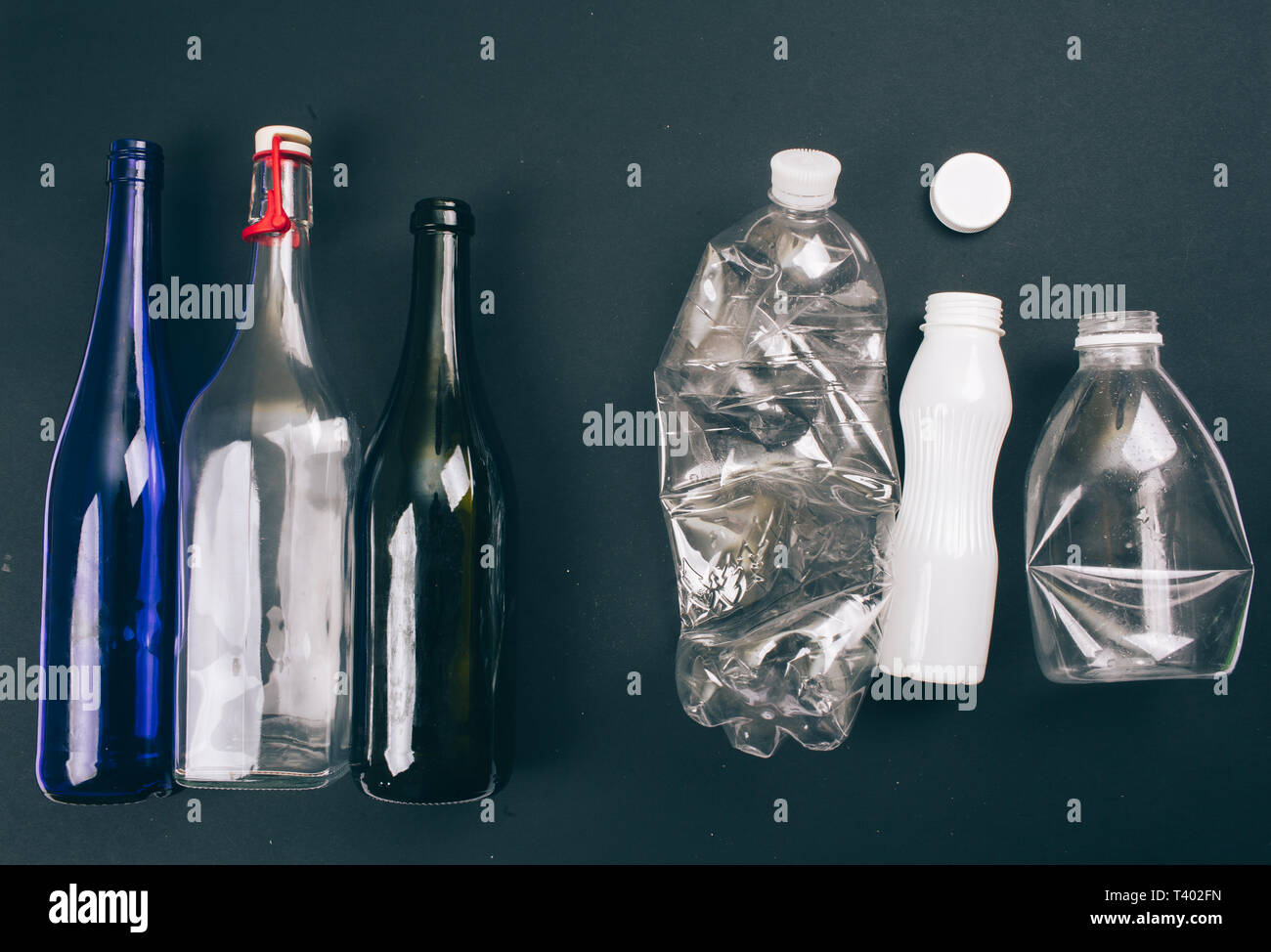 Sorting waste. Three empty colorful glass and plastic bottles are