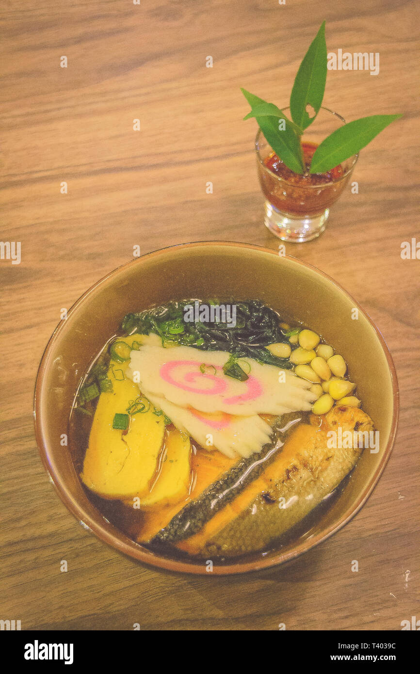 Japanese ramen with shoyu broth and grilled salmon fillet and japanese