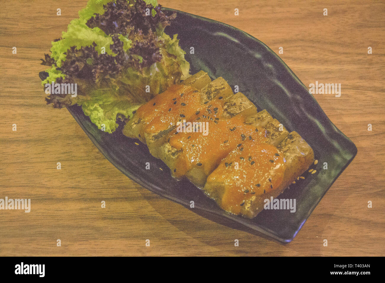 grilled japanese taro yam cake with black sesame seeds and lettuce