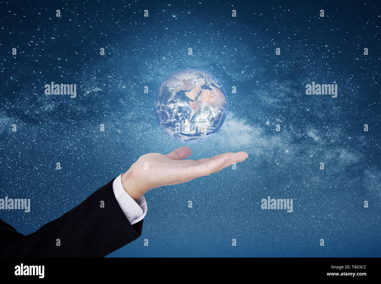 Businessman showing the world on hand, on blue starry space background. Element of this image are furnished by NASA Stock Photo