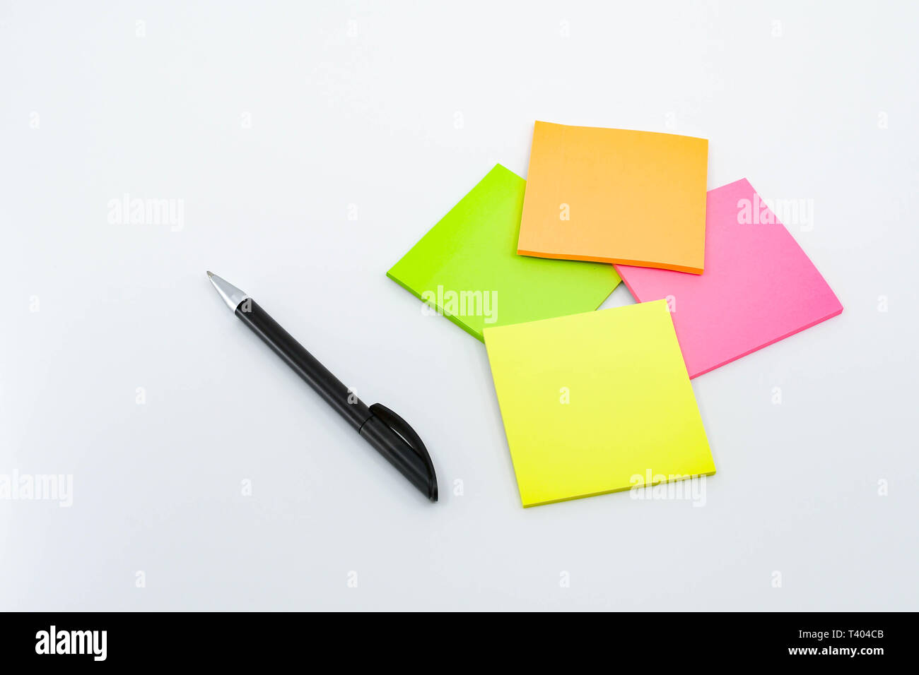 Pen And Note Pads In Day Glo Colors Isolated Against A Plain White Background Stock Photo Alamy