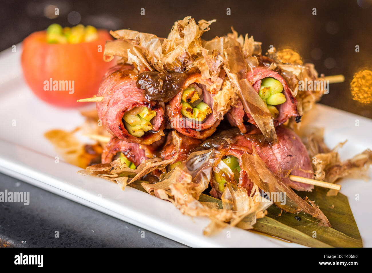 tender asparagus wrapped in beef bacon and grilled then topped with bonito flakes Stock Photo
