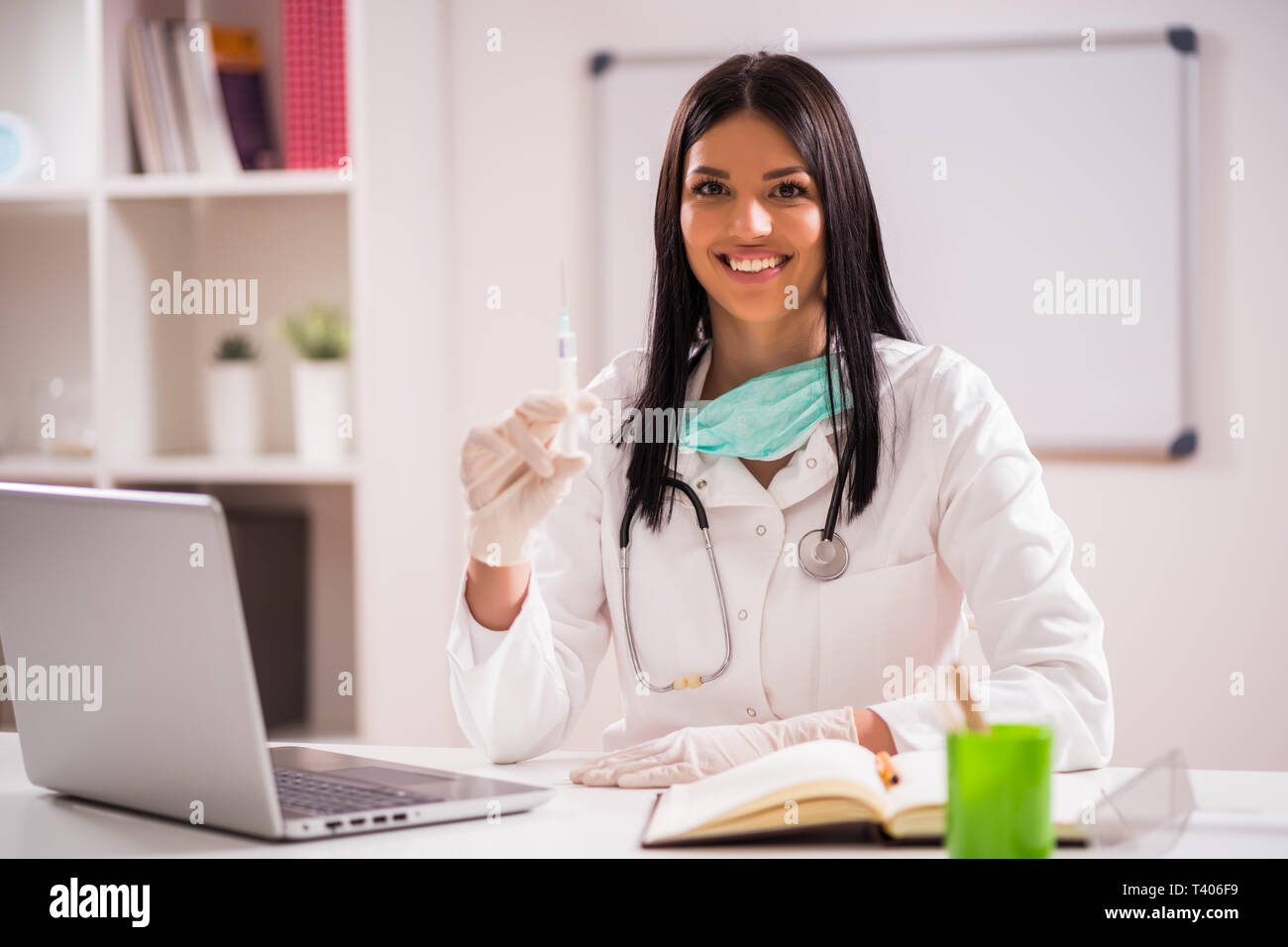 Young doctor is talking about importance of vaccination. Stock Photo