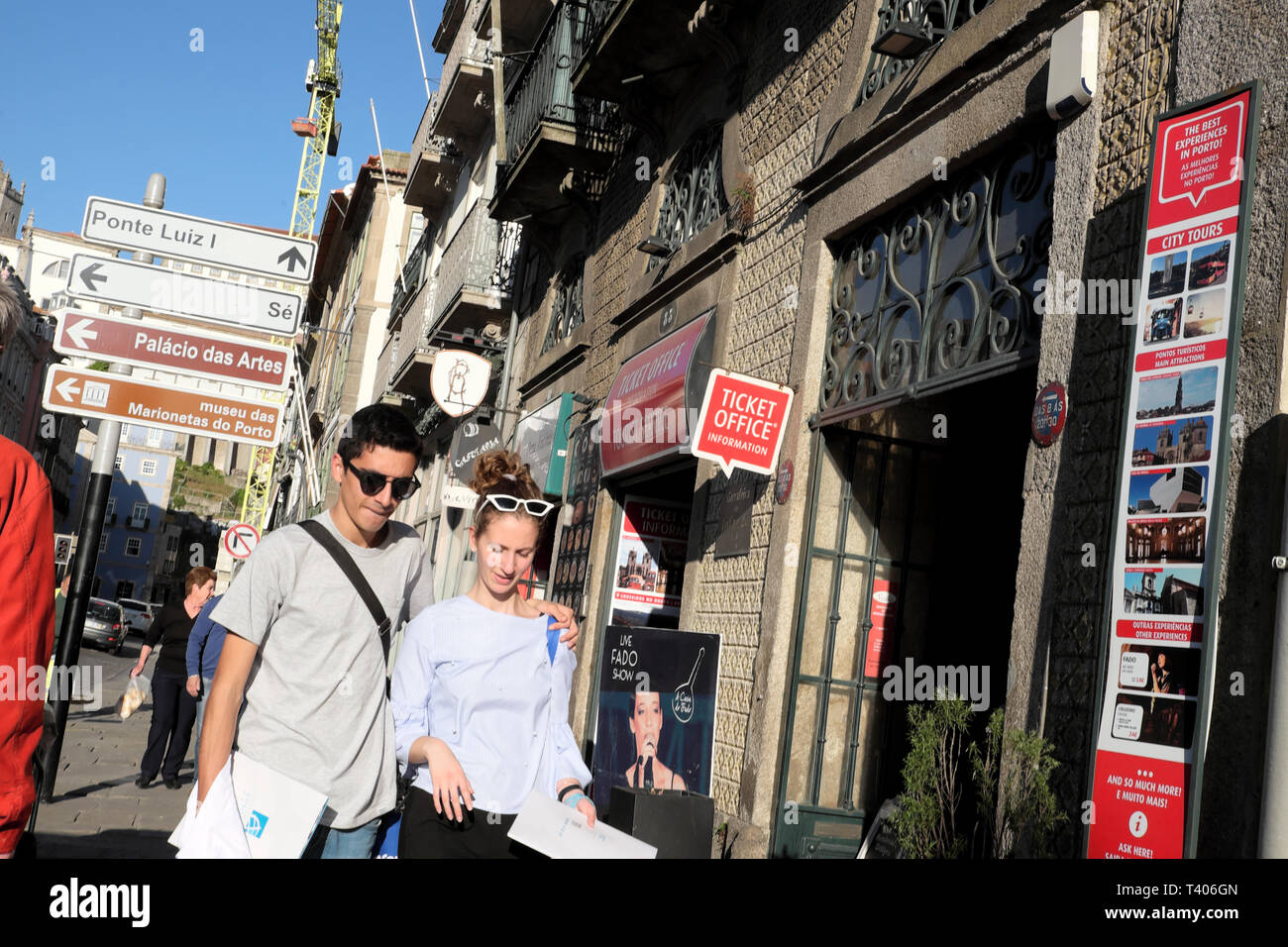 A young attractive couple walking along a street in Porto Portugal Europe EU    KATHY DEWITT Stock Photo