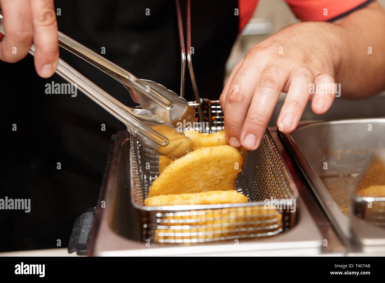 Chef is cooking chicken nuggets in a deep fryer Stock Photo Alamy