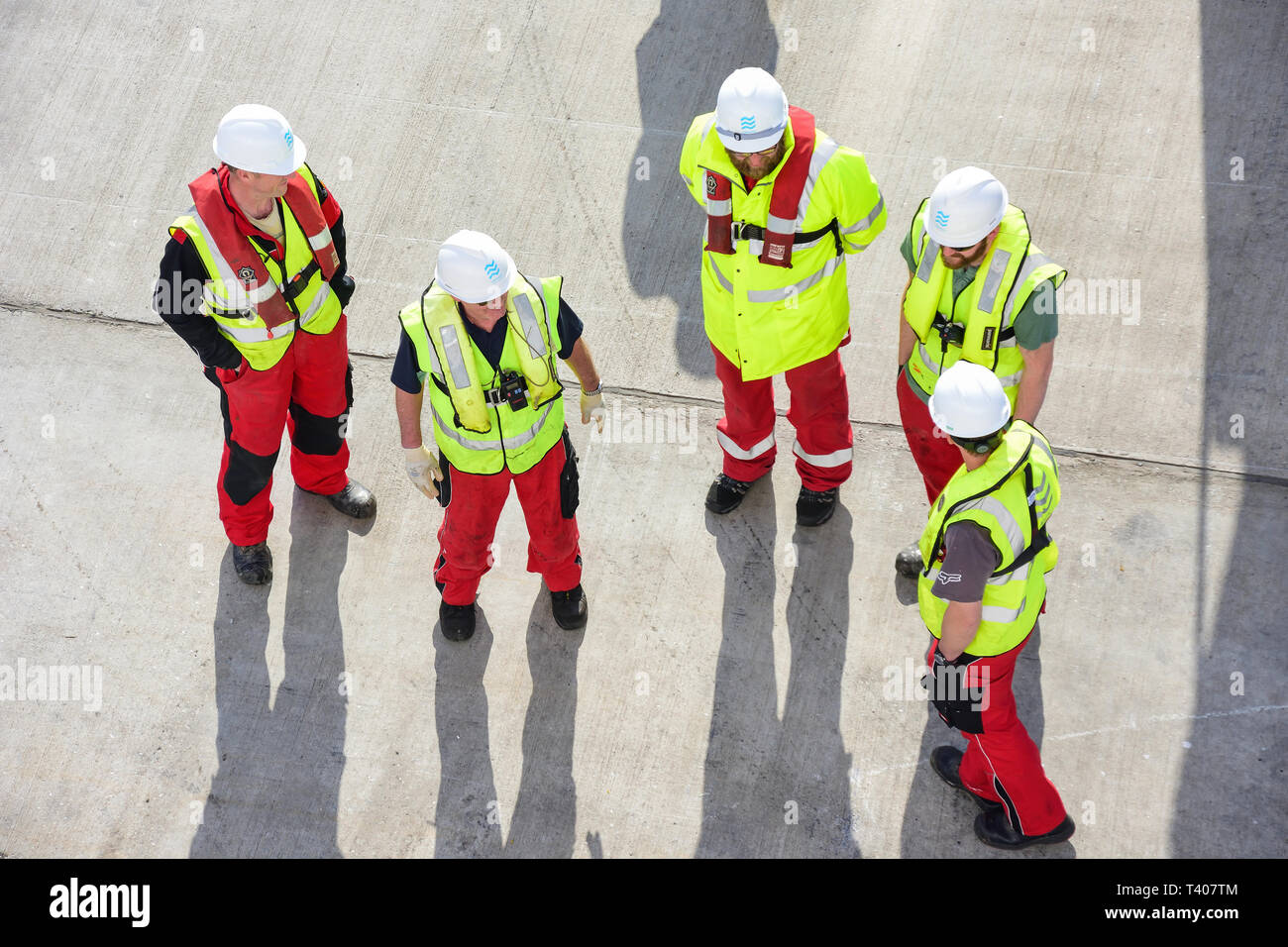 Workmen with hard hats on cruise ship wharf, Lerwick, Shetland, Northern Isles, Scotland, United Kingdom Stock Photo