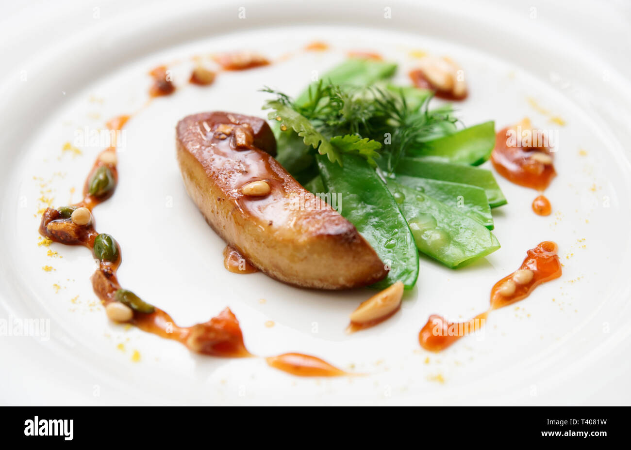Fried foie gras with caramelized nuts and vegetables Stock Photo
