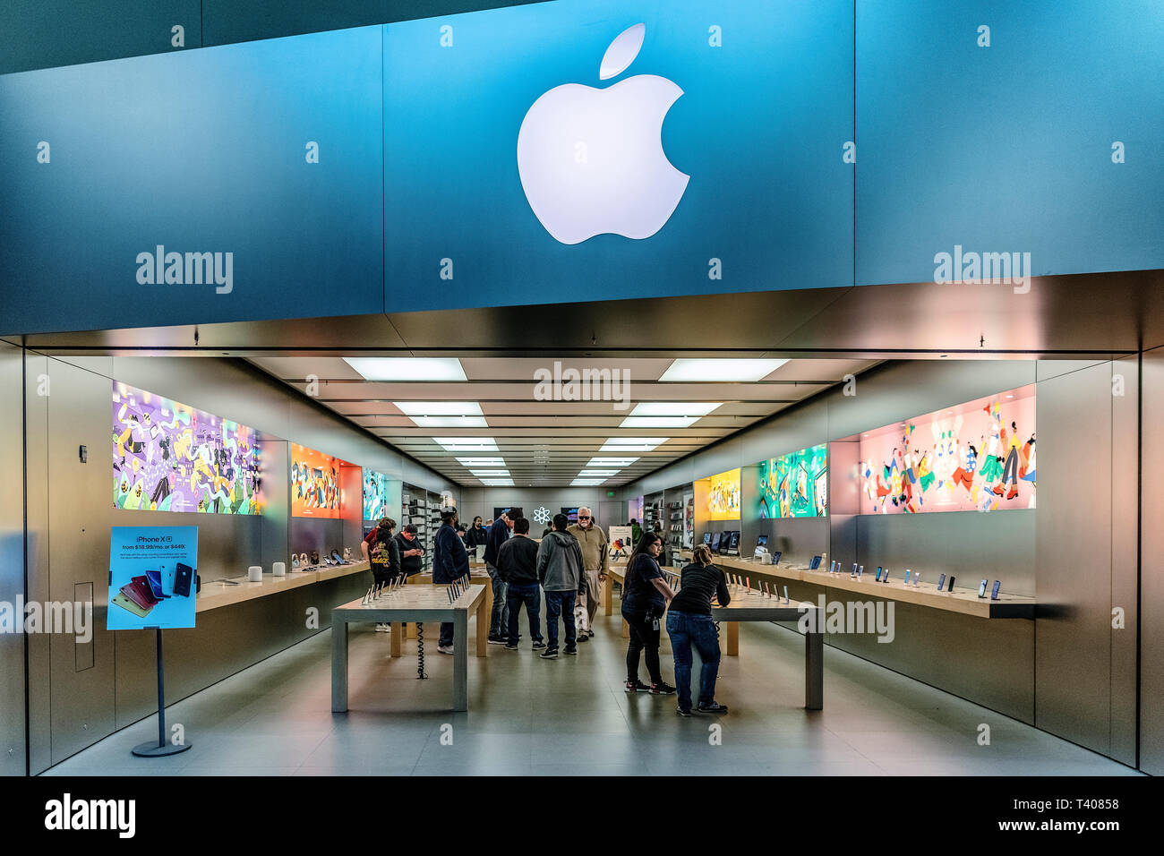 Apple Store signage at Lenox Square in the Buckhead area of Atlanta,  Georgia, with metallic Apple logo on glass reflecting a nearby skyscraper.  (USA Stock Photo - Alamy