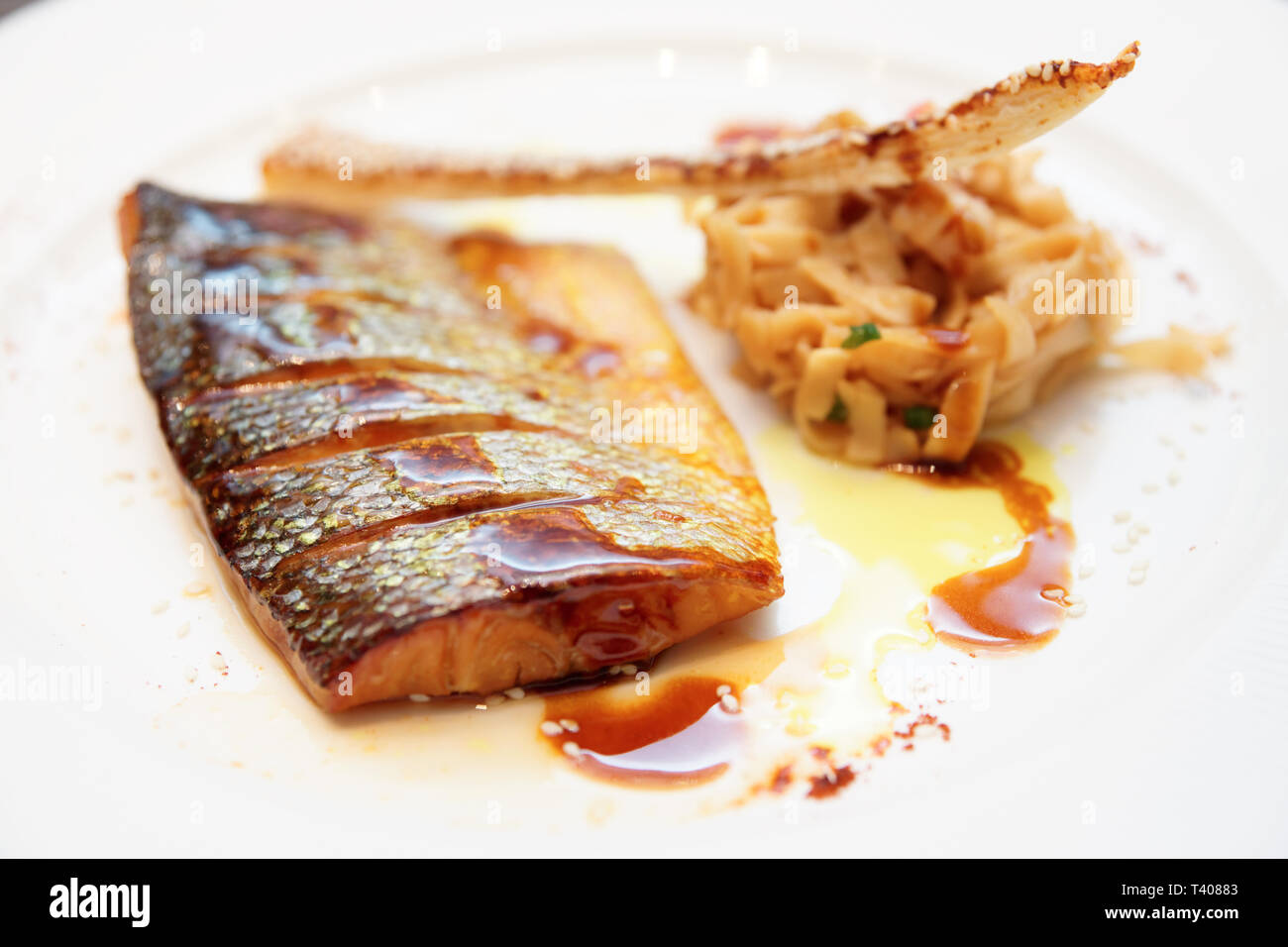 Seabass cooked in asian style with teriyaki sauce Stock Photo