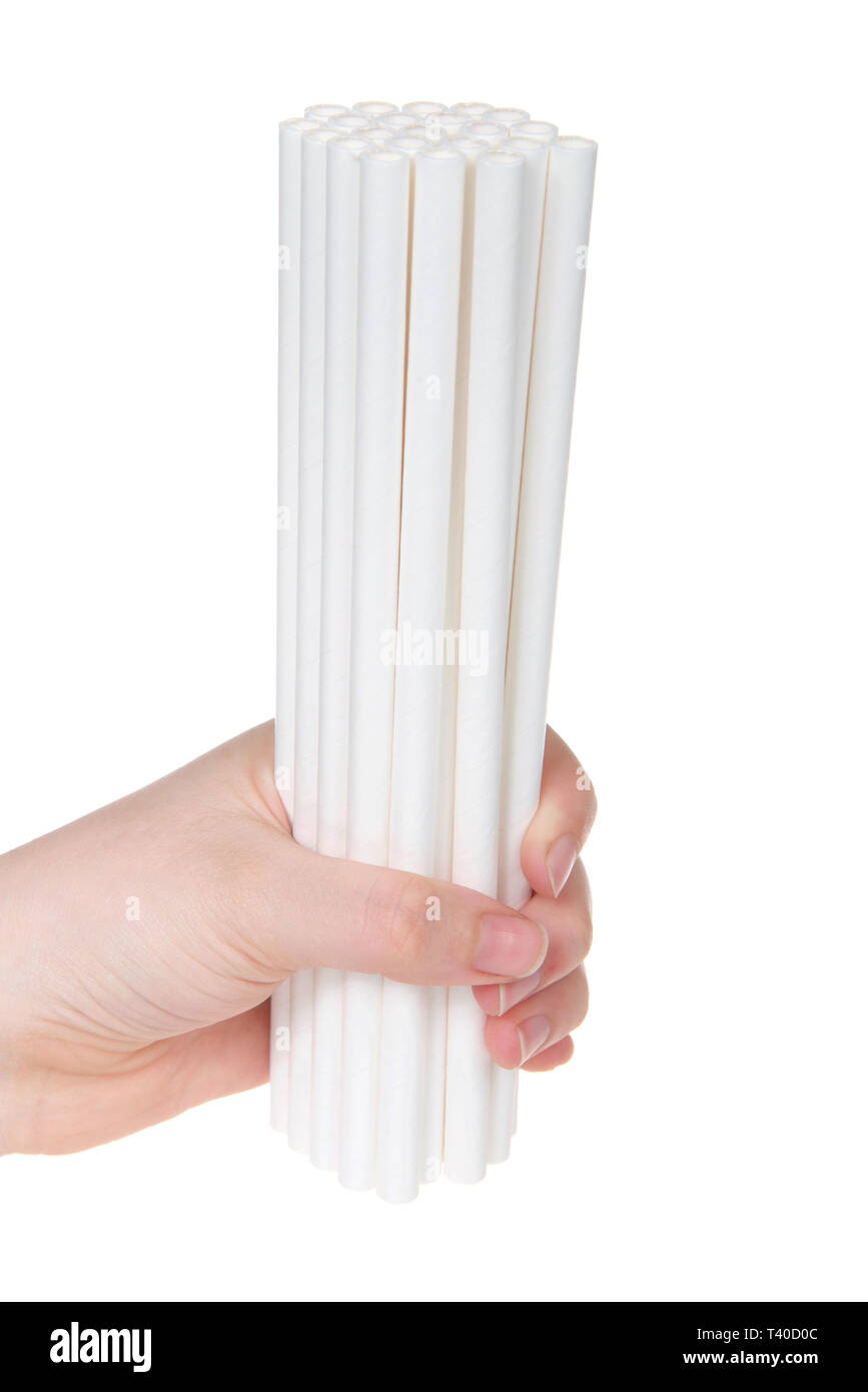 Young caucasian hand holding paper biodegradable straws, isolated on white background. Stock Photo