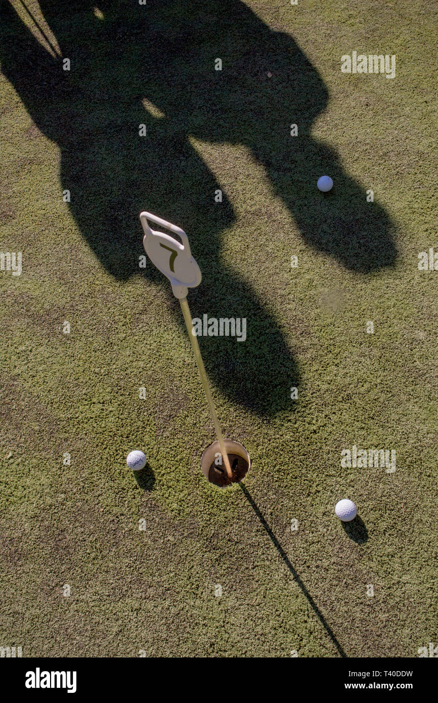 Golf Lessonn Shadow the shadow of 2 golfers on a putting green Stock Photo - Alamy