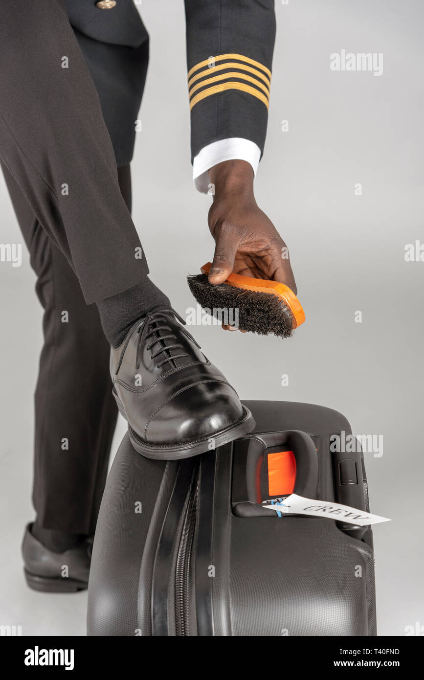 Airline Pilot Brushing His Black Uniform Shoes Stock Photo Picture and  Royalty Free Image Image 121278868