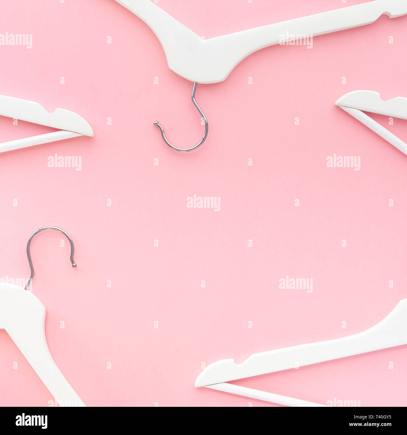 Creative top view flat lay white wooden hangers pastel millennial pink ...