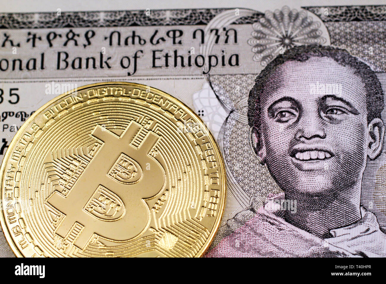 A Close Up Image Of A Shiny Gold Physical Bitcoin With A One - 