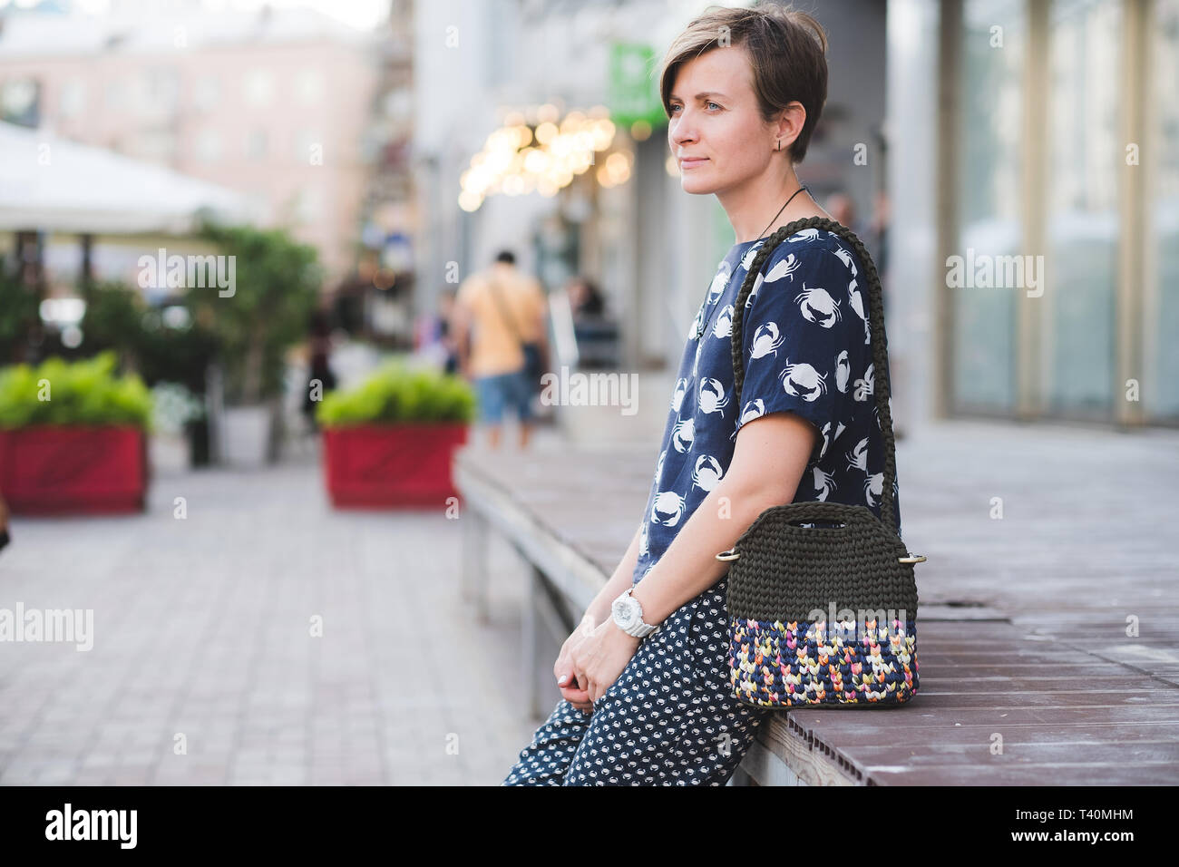 Close up photo of woman bag in hands of fashionable woman. Elegant outfit. Female fashion concept Stock Photo