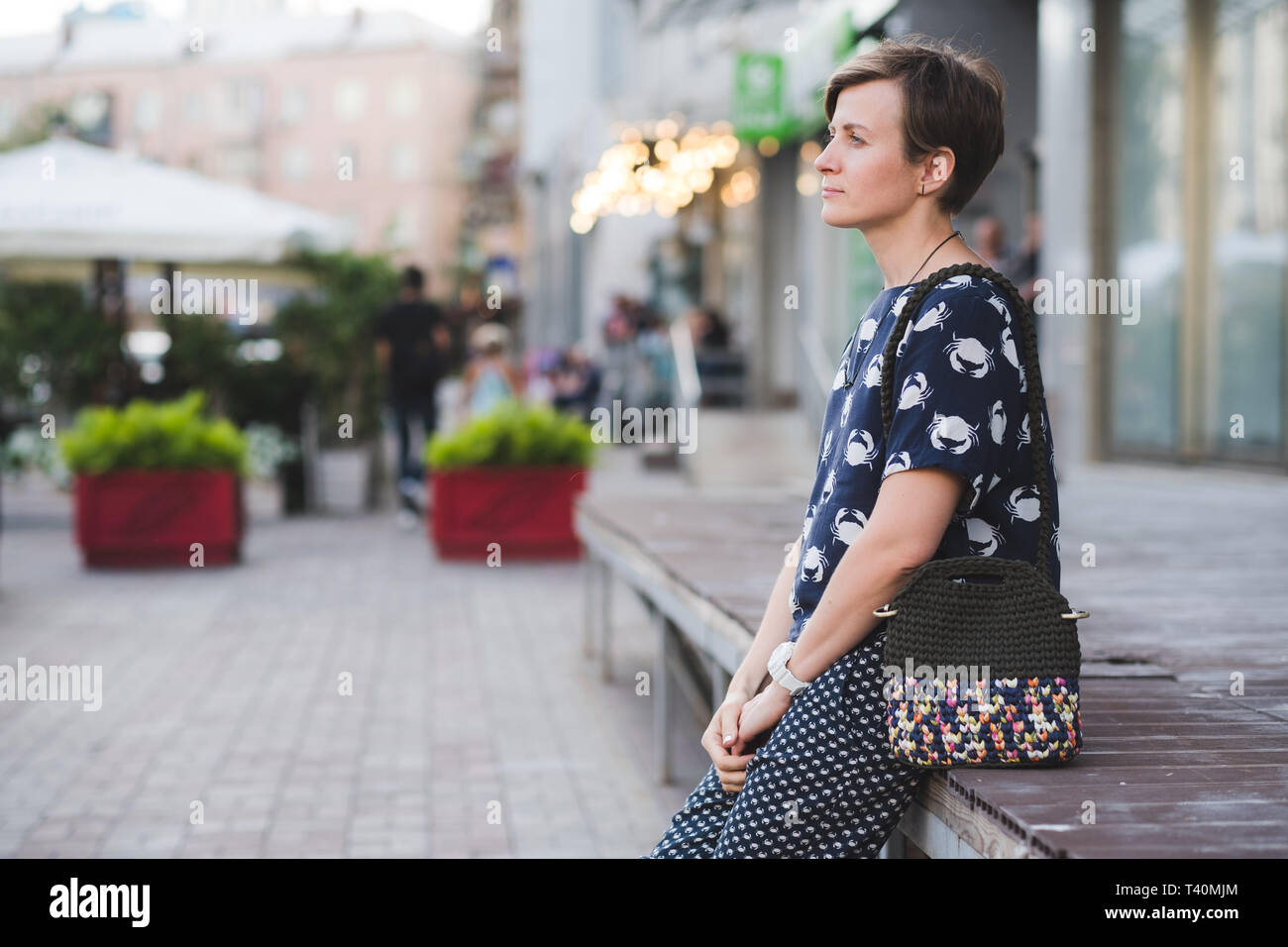 Close up photo of woman bag in hands of fashionable woman. Elegant outfit. Female fashion concept Stock Photo