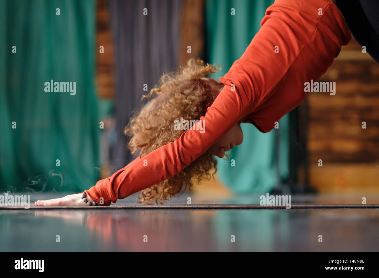 woman practicing yoga Downward facing dog exercise, adho mukha svanasana pose Stock Photo