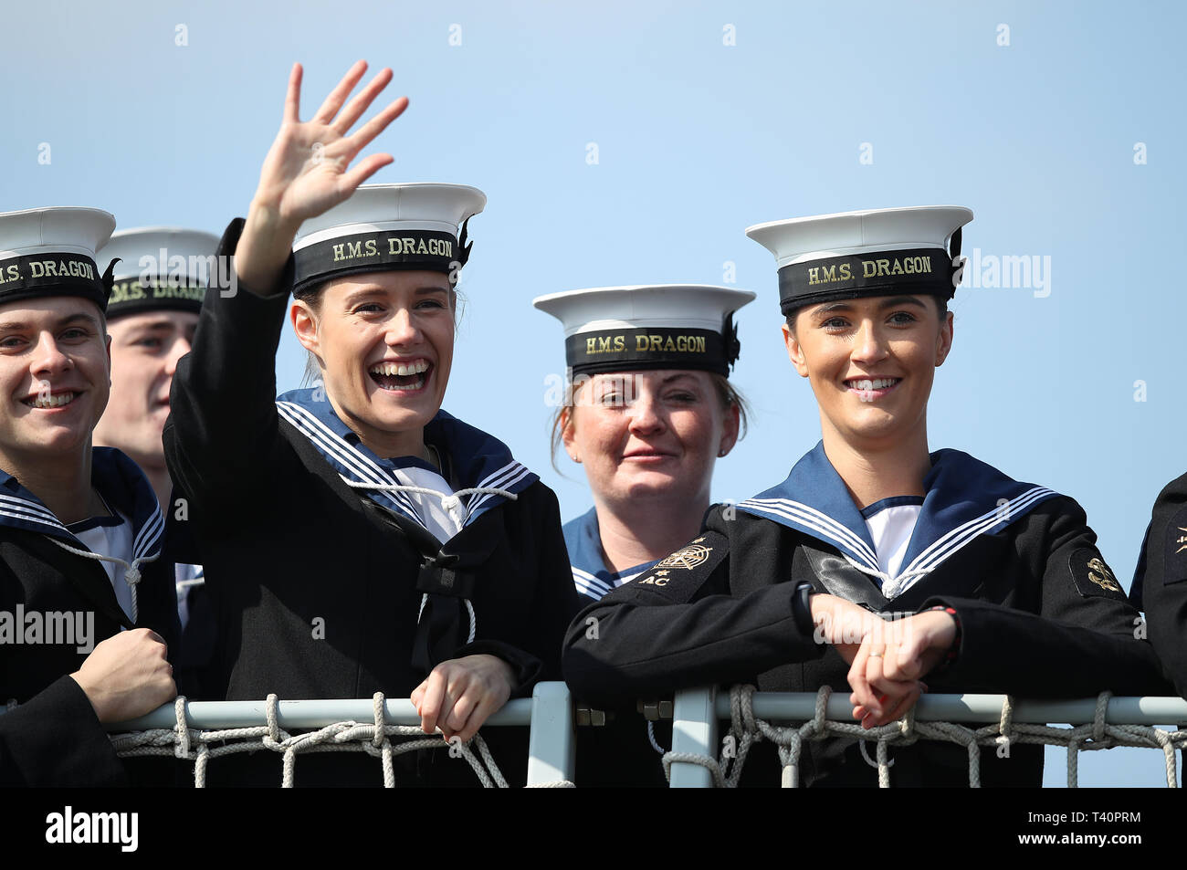 Crew members onboard HMS Dragon wave to the waiting crowd as she returns to Portsmouth Naval Base after a seven-month Gulf mission. Stock Photo