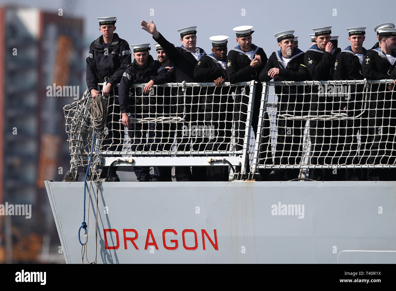 crew-members-onboard-hms-dragon-wave-to-the-waiting-crowd-as-she