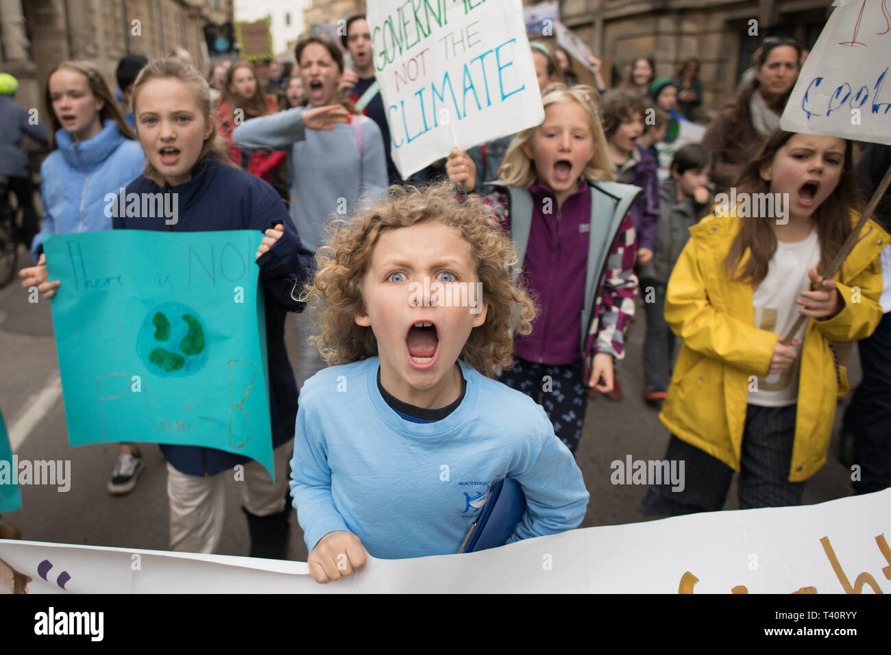 Schoolchildren march through Cambridge city centre to take part in a 'die-in' climate change protest where they were campaigning against the use of fossil fuels. Stock Photo