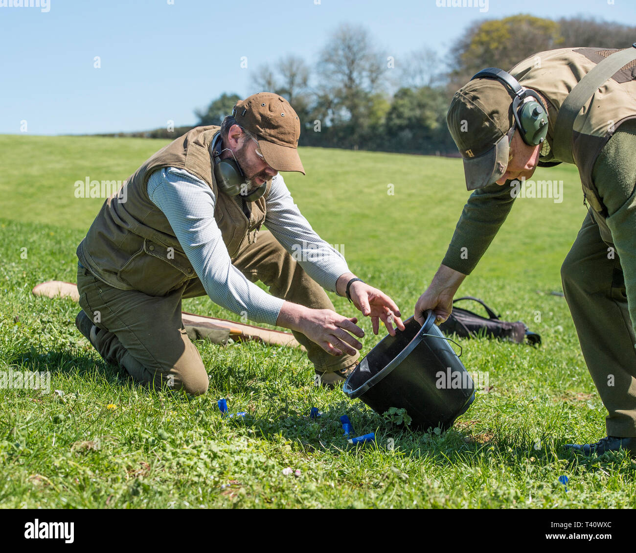 collecting empty cartridges after shooting Stock Photo
