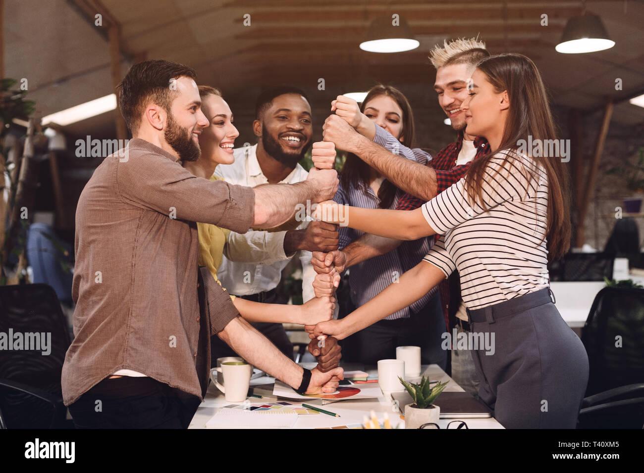 Unity concept. Colleagues putting their fists together Stock Photo