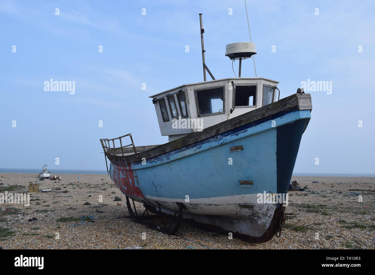 sea scene at Dungeness Kent, a fishing boat is moored on the pebble ...