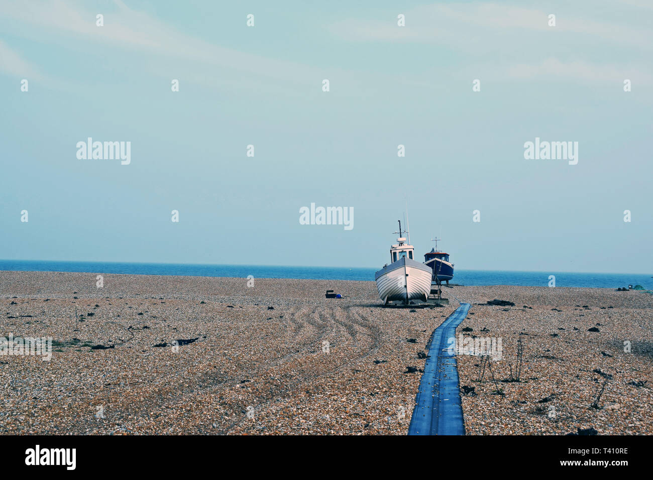 sea scene at Dungeness Kent, a fishing boat is moored on the pebble ...
