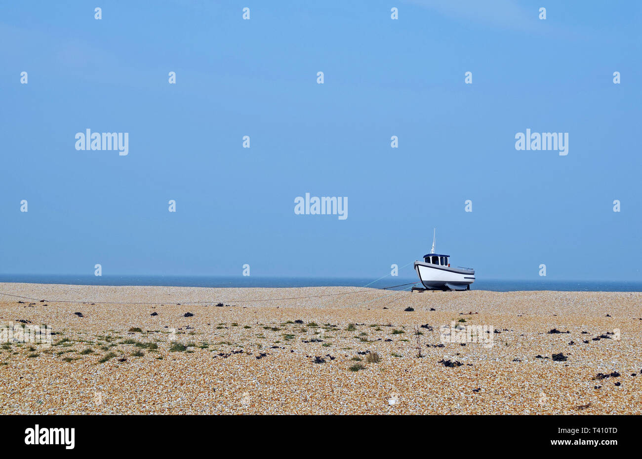 sea scene at Dungeness Kent, a fishing boat is moored on the pebble ...